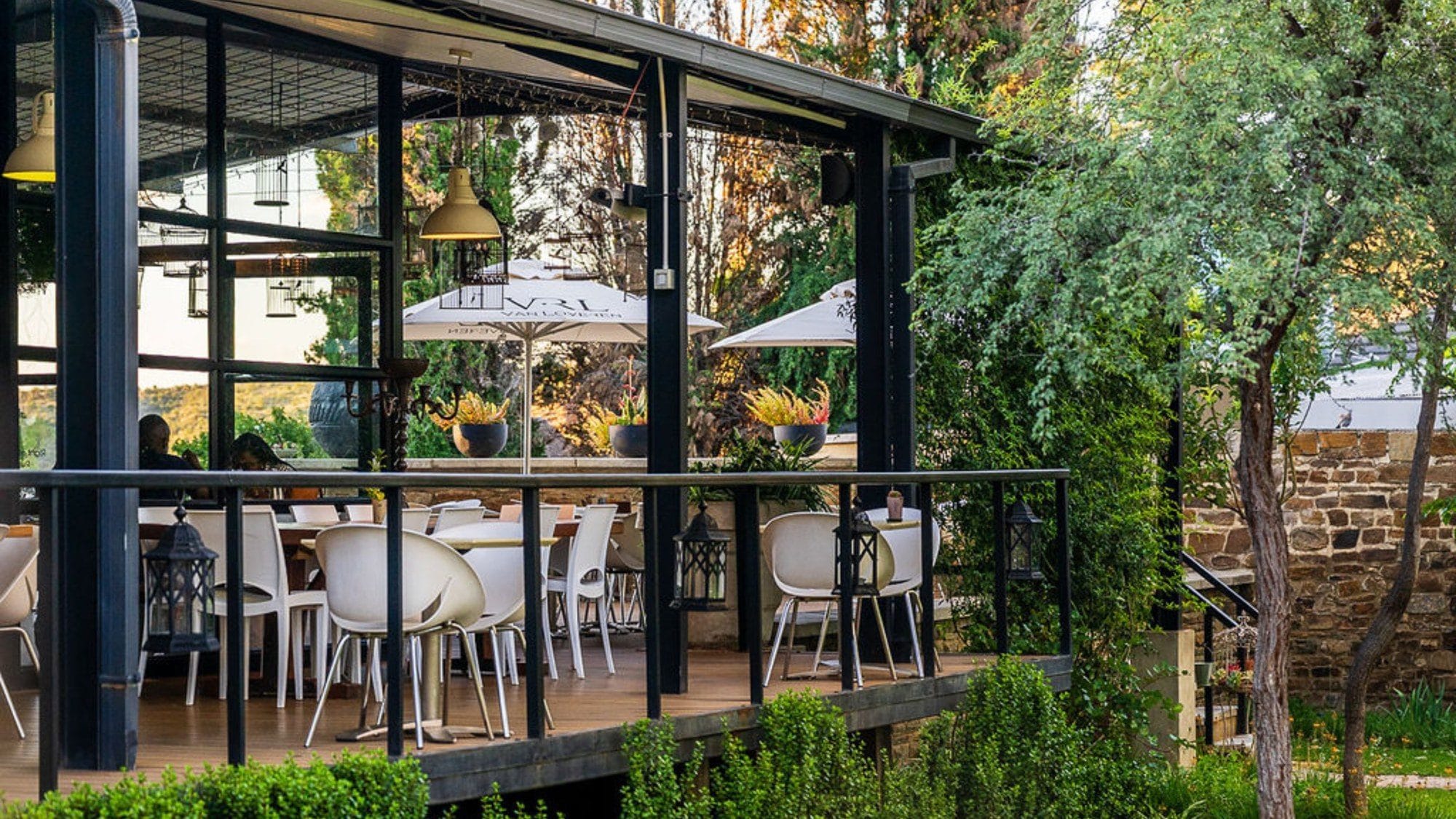 Birdcage Restaurant deck with umbrellas in the Droombos garden