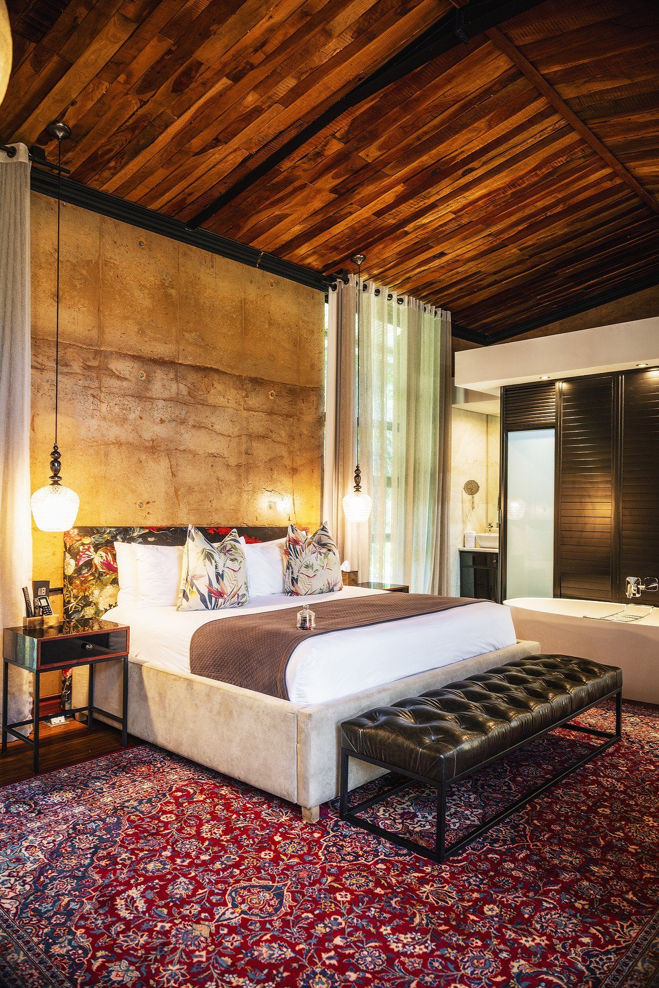 Droombos Suite with rammed earth wall and king bed