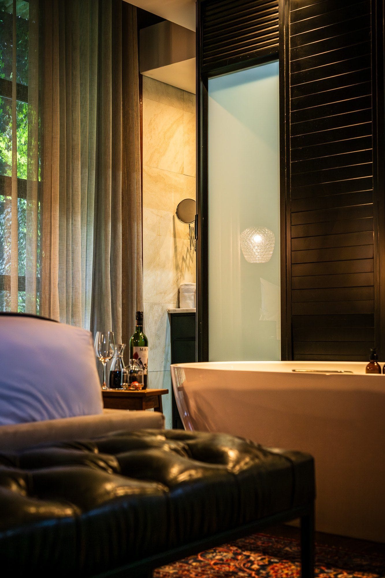 Freestanding bath beside the suite bedroom