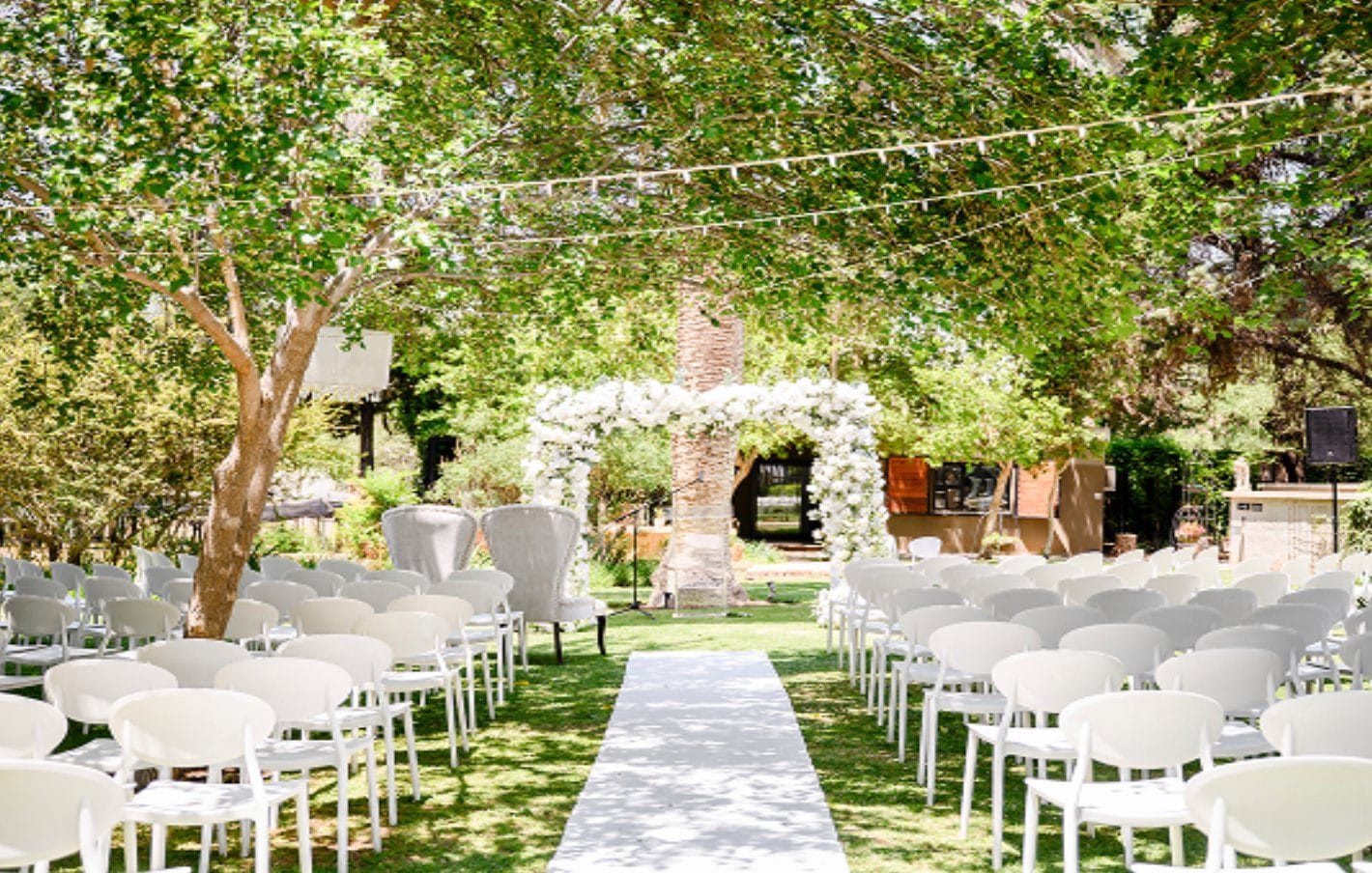 Garden wedding ceremony aisle with white chairs at Droombos Estate