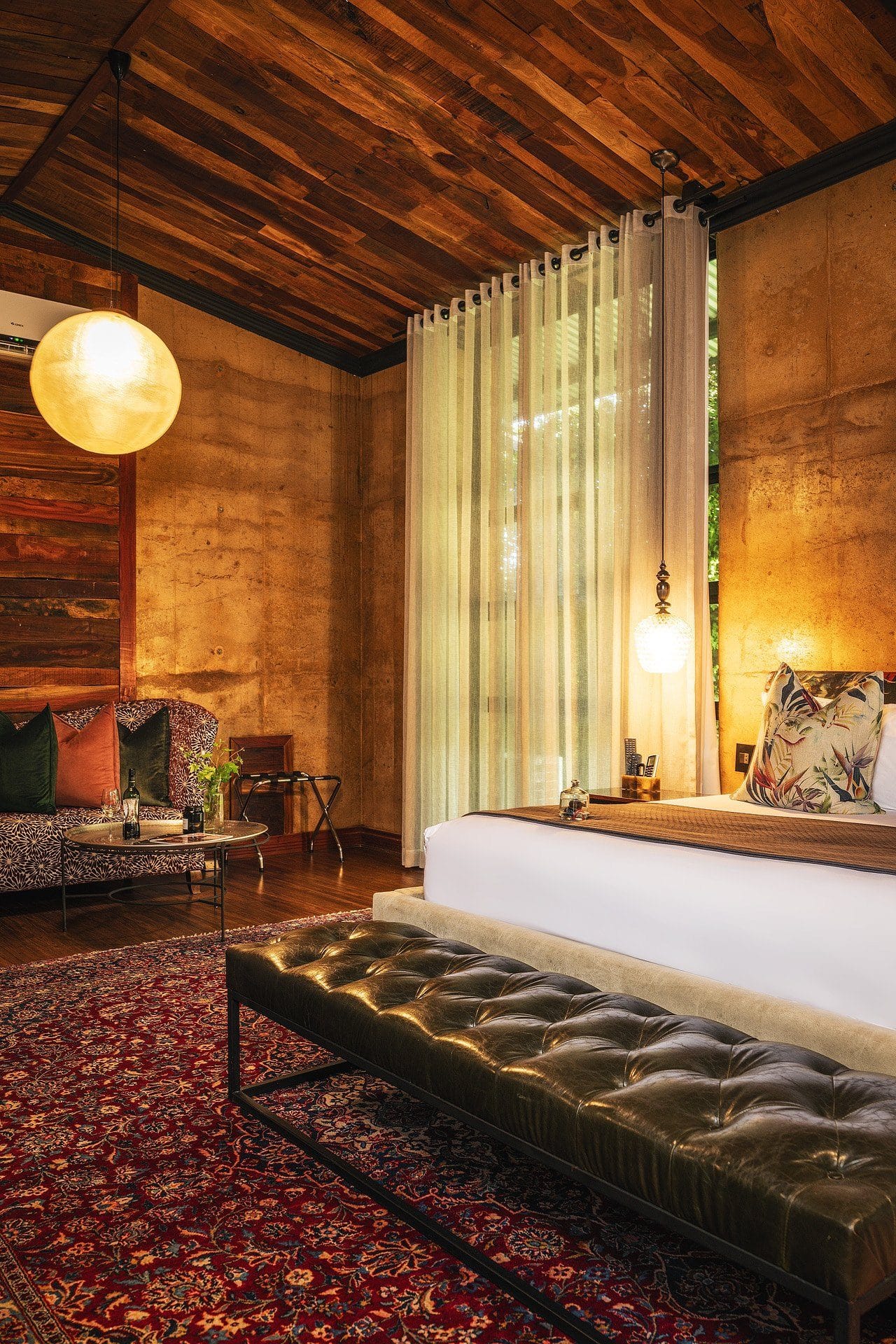 Luxury suite with rammed earth walls and timber ceiling